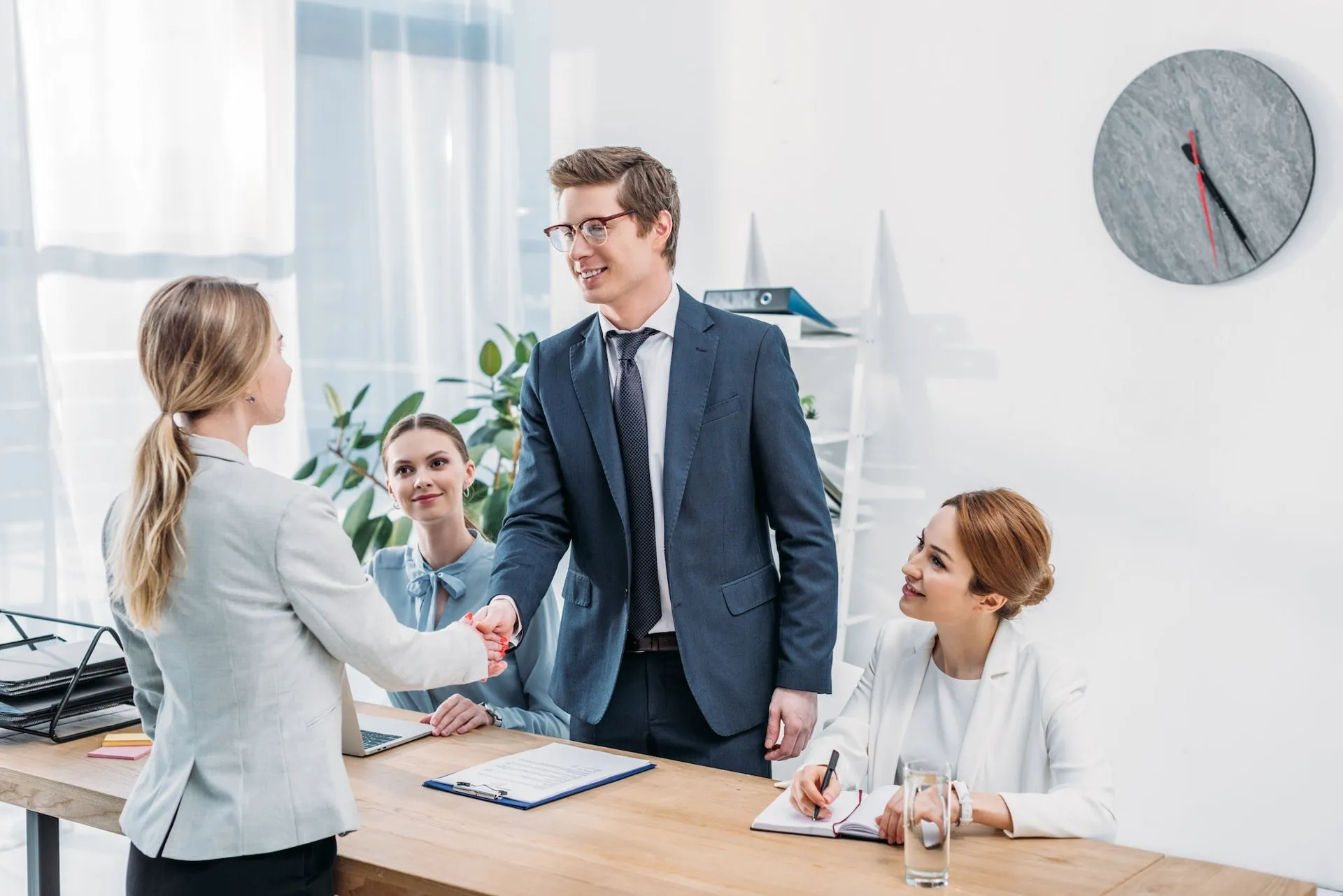 A candidate shaking hands with a hiring manager