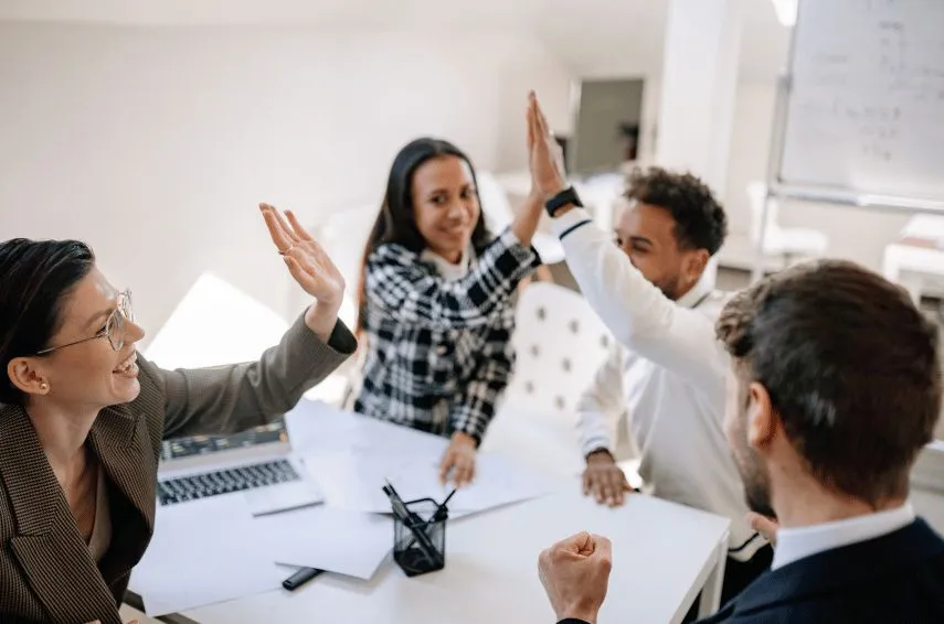 Colleagues giving each other a high five