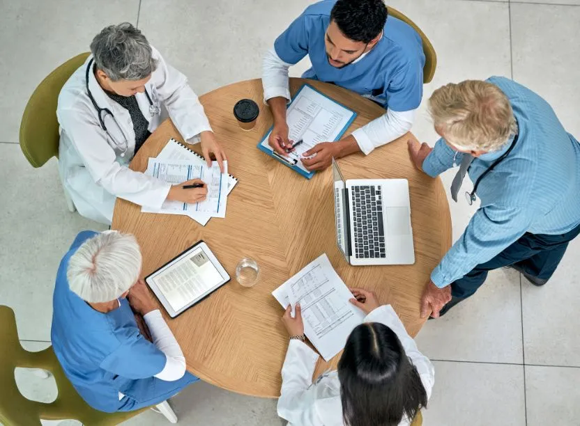 A team meeting around a table, seen from above